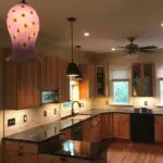 A kitchen with wooden cabinets and black appliances.