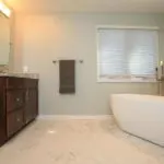 A bathroom with a large tub and sink.