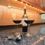 Red Wine Bottle and Glass On Countertop